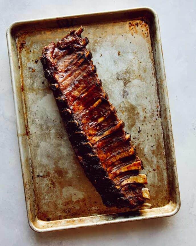 Oven baked ribs on a baking sheet.