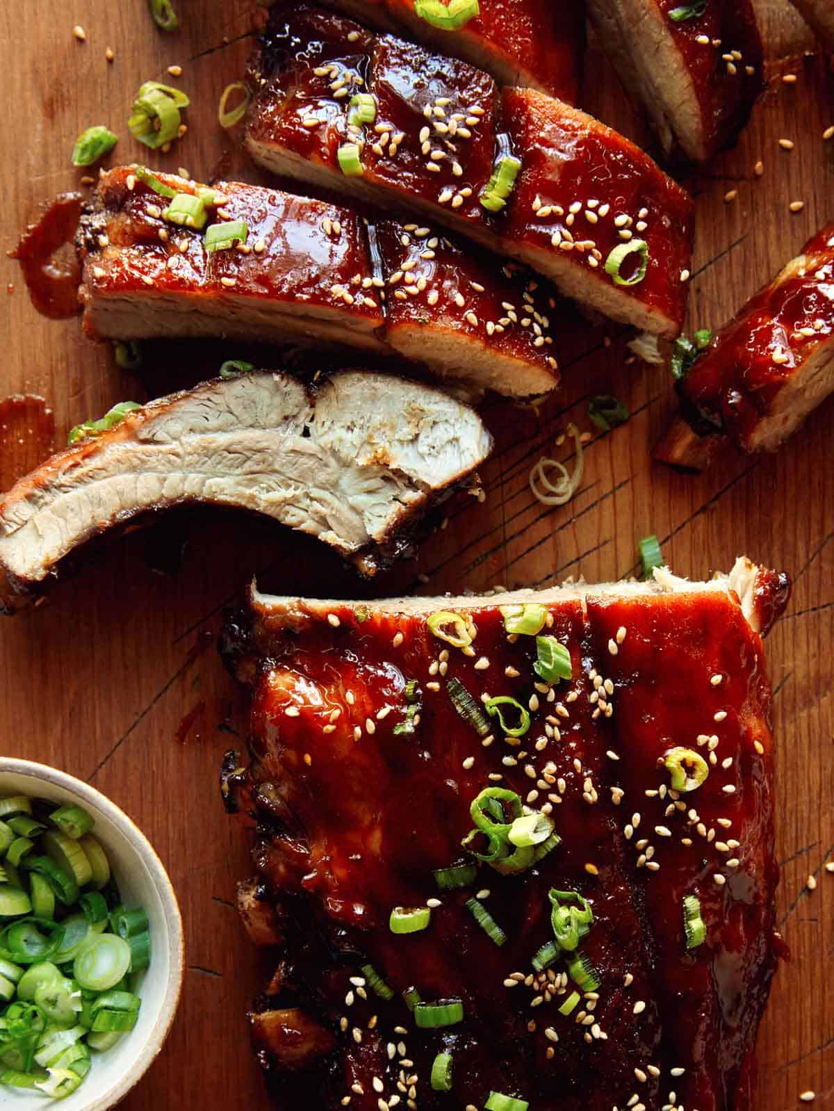 Oven baked sticky ribs on a cutting board. 