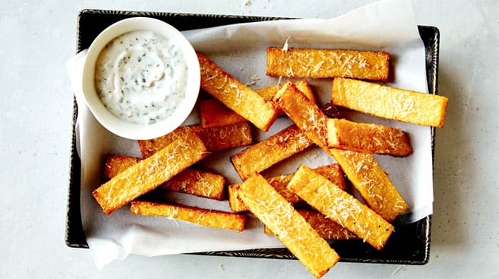 Polenta fries in a basket served with tarragon aioli.