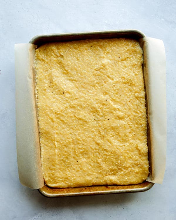 Polenta spread out into a baking sheet.