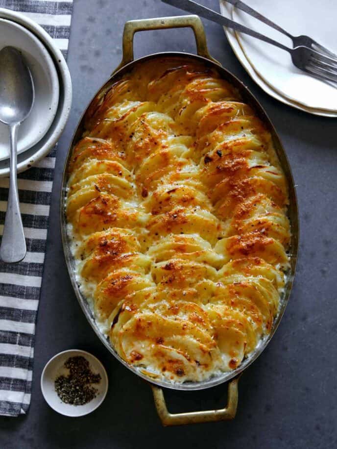 Close up on a casserole dish of cheesy potatoes gratin.