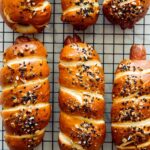 A close up of pretzel dogs on a cooling rack.