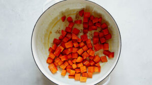Sweet potato chunks cooking in a stock pot.