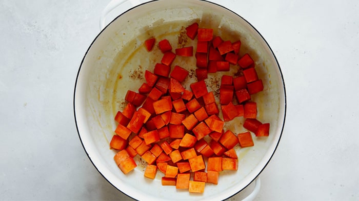 Sweet potato chunks cooking in a stock pot.