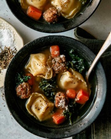 Tortellini Soup recipe in two bowls with spoons next to it.
