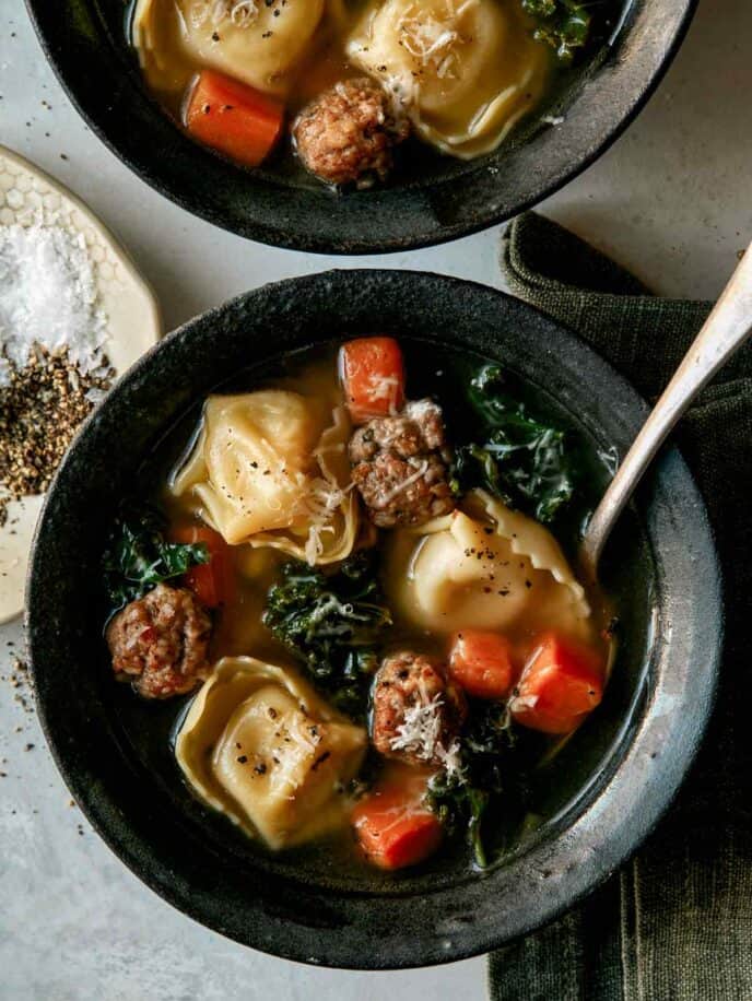 Tortellini Soup recipe in two bowls with spoons next to it.