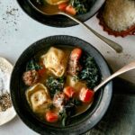 Tortellini Soup recipe in two bowls with parmesan next to it.