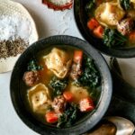 Tortellini Soup recipe in two bowls with parmesan next to it.