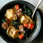 Close up on one bowl of tortellini soup.