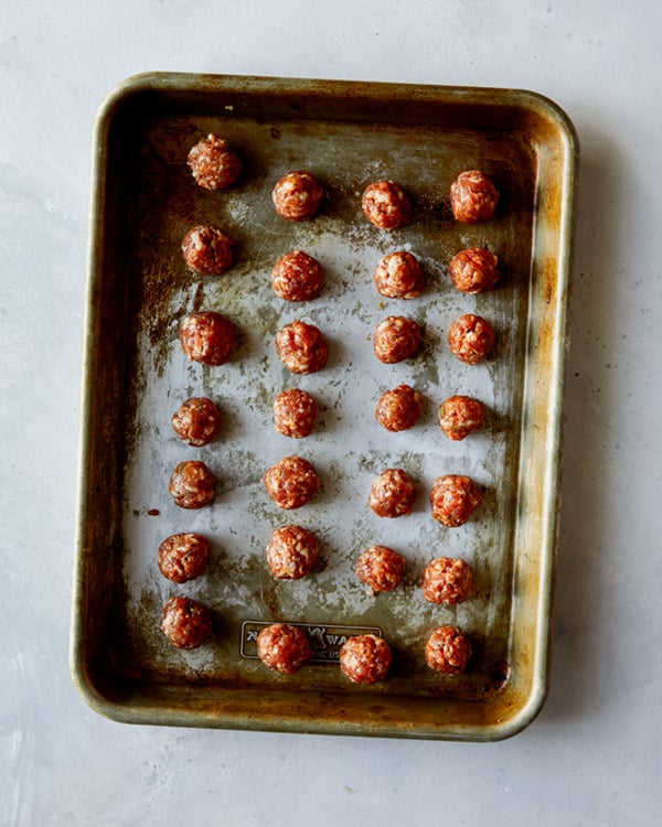 Turkey sausage meatballs to make tortellini soup on a baking sheet. 