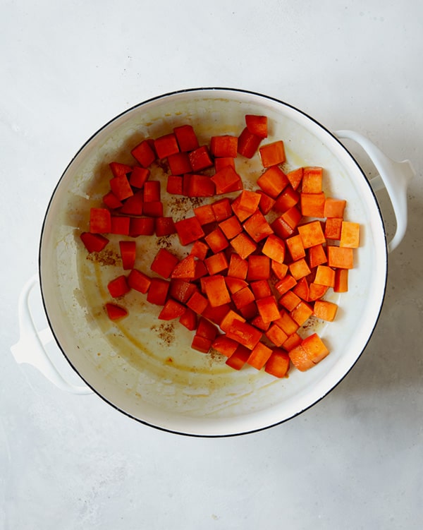 Sweet potato chunks cooking in a stock pot.