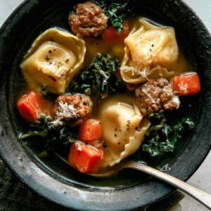 Close up on one bowl of tortellini soup.