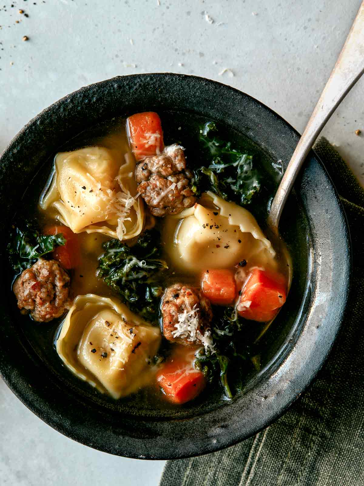 Close up on one bowl of tortellini soup. 