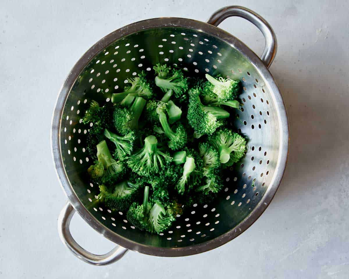 Boiled broccoli in a colander. 