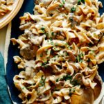 Beef Stroganoff on a platter with chives on top.