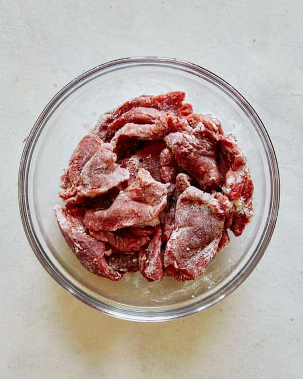 Beef slices coated in cornstarch for beef stroganoff.