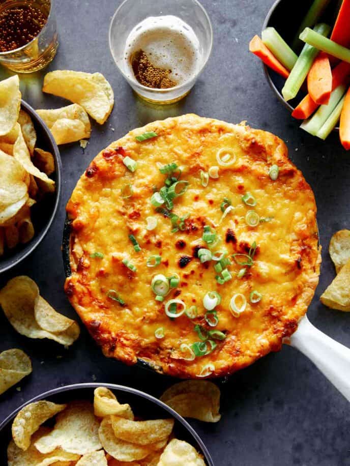 Buffalo Chicken Dip in a skillet with green onions on top.