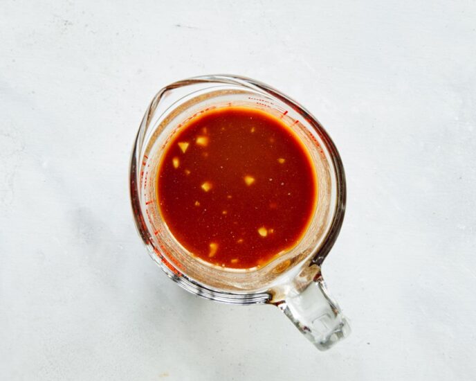 Cashew chicken sauce in a glass bowl mixed together.