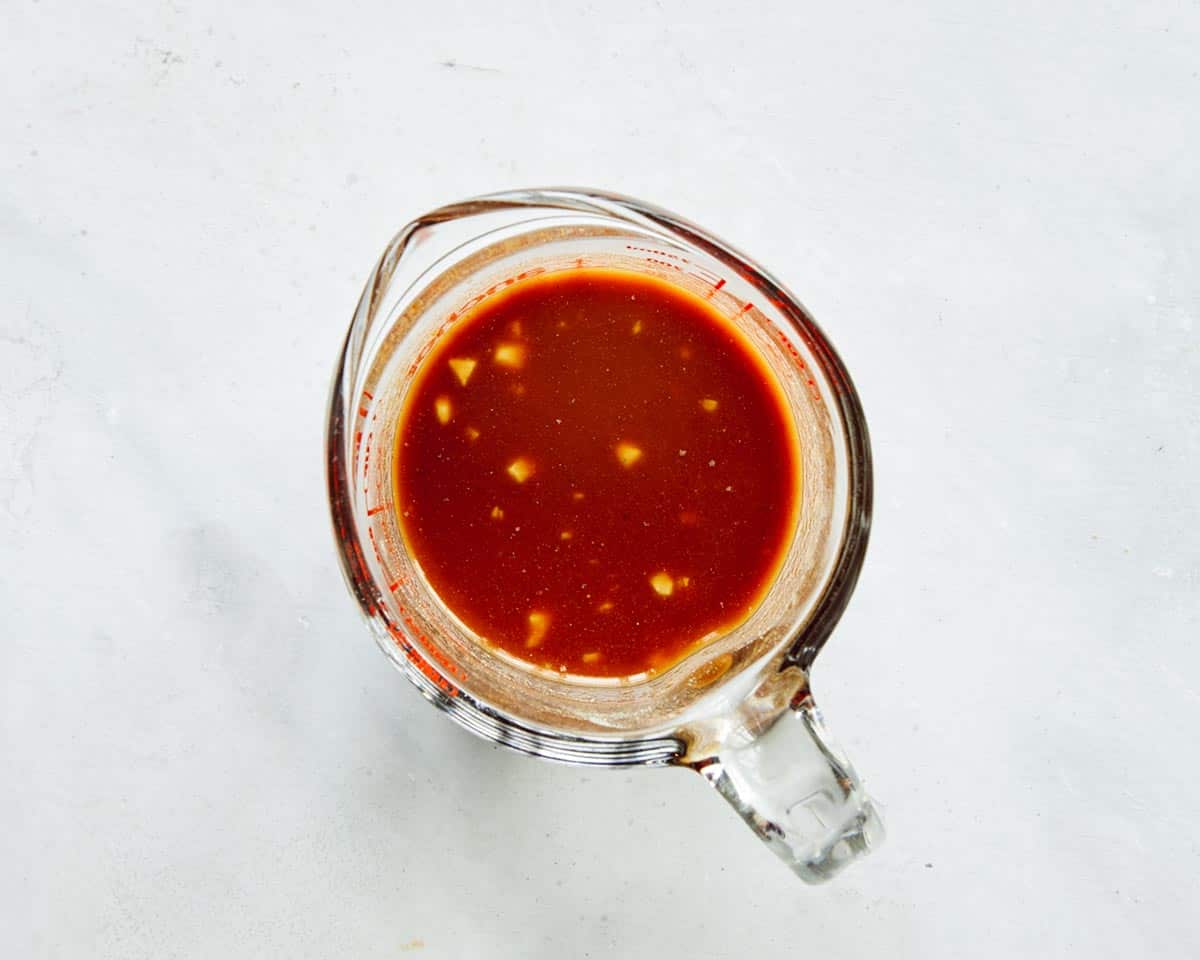 Cashew chicken sauce in a glass bowl mixed together.
