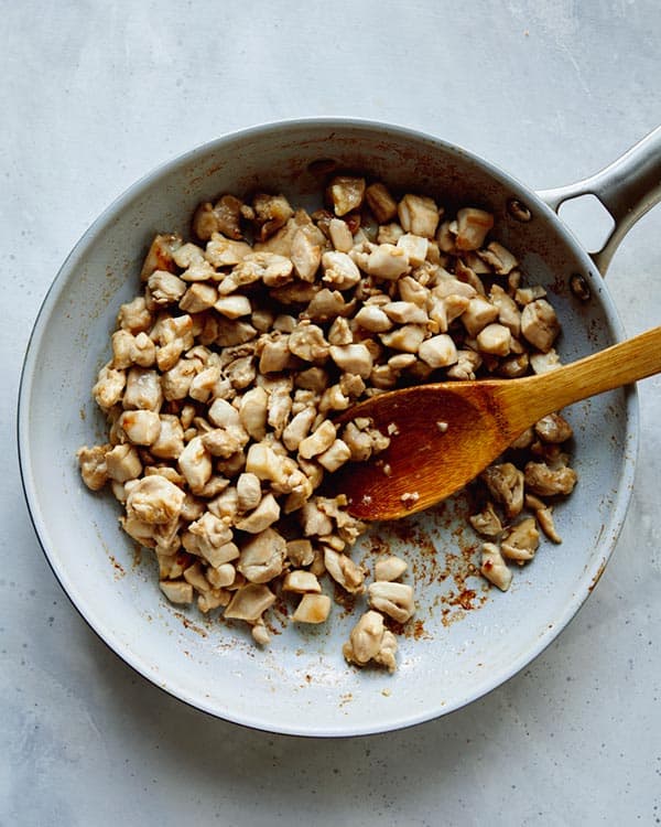 Chicken in a skillet to make a cashew chicken recipe.