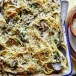 Chicken tetrazzini in a baking dish with a spoon in it.