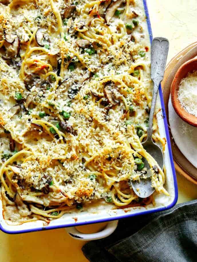 Chicken tetrazzini in a baking dish with a spoon in it.