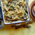 Chicken tetrazzini in a baking dish with a spoon in it.