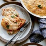 Tuscan chicken recipe served onto two plates.