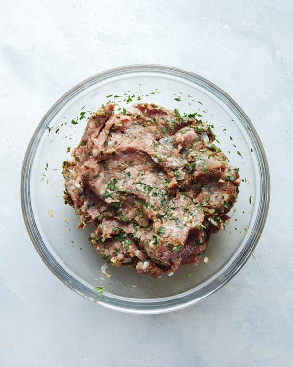 Ground lamb for Lamb Kofta combined in a glass bowl.