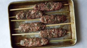 Lamb Kofta on a skewers ready to be grilled.