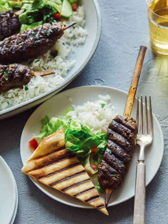 Lamb kofta recipe on a plate with rice and pita.