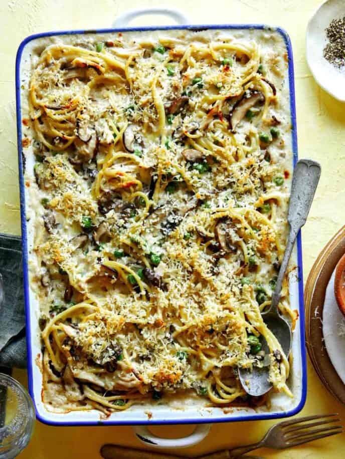Chicken tetrazzini in a baking dish with a spoon in it.