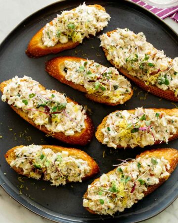 Smoked Trout on crostini on a plate.