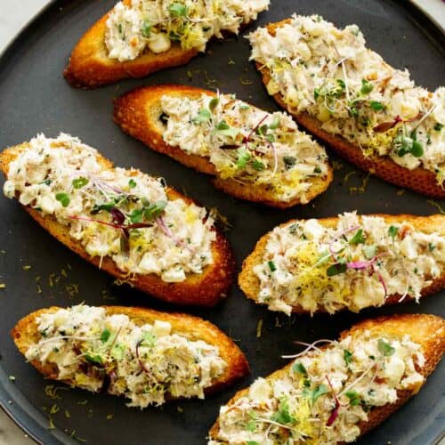 Smoked Trout on crostini on a plate.