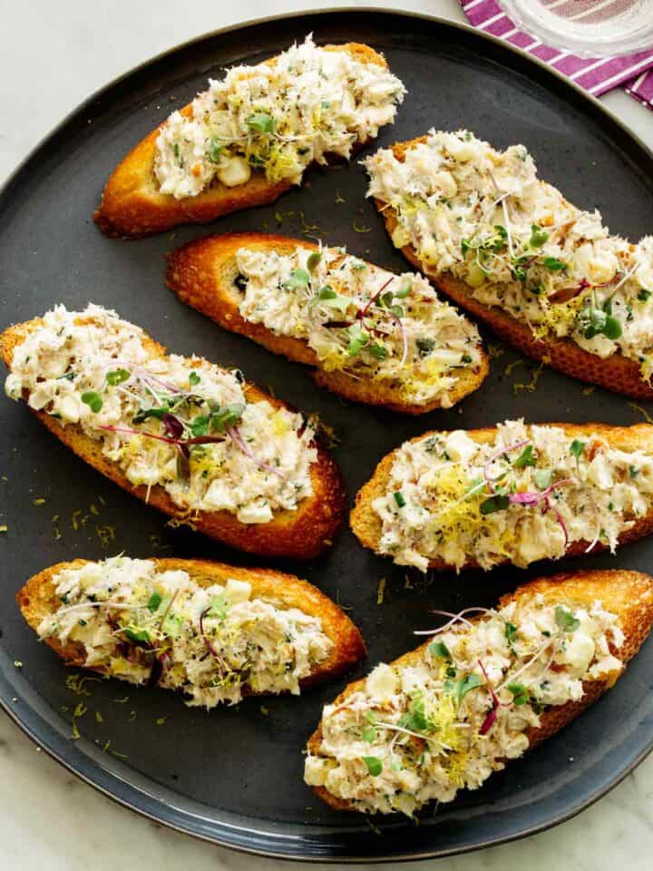 Smoked Trout on crostini on a plate.