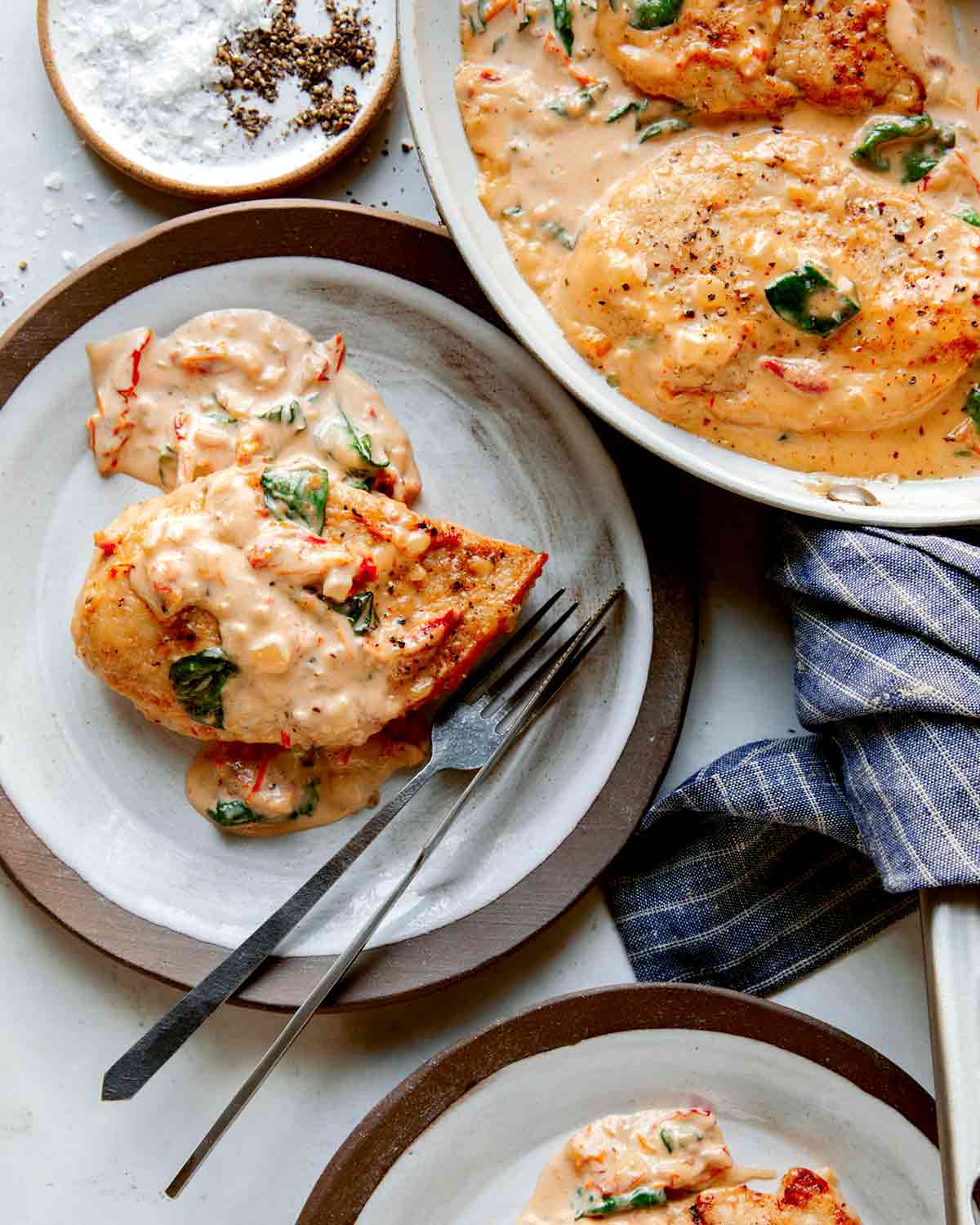 Tuscan chicken recipe served onto two plates.
