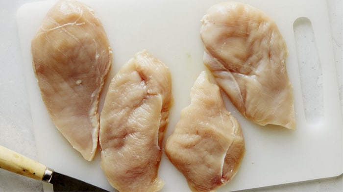 Chicken breasts sliced in half for tuscan chicken recipe.