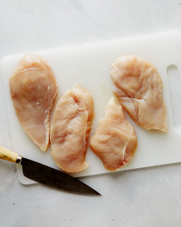 Chicken breasts sliced in half for tuscan chicken recipe.