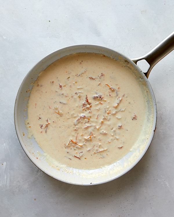 Making the sauce for Tuscan Chicken in a skillet.