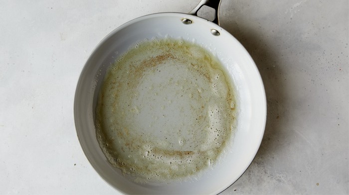 Melted butter in a skillet.