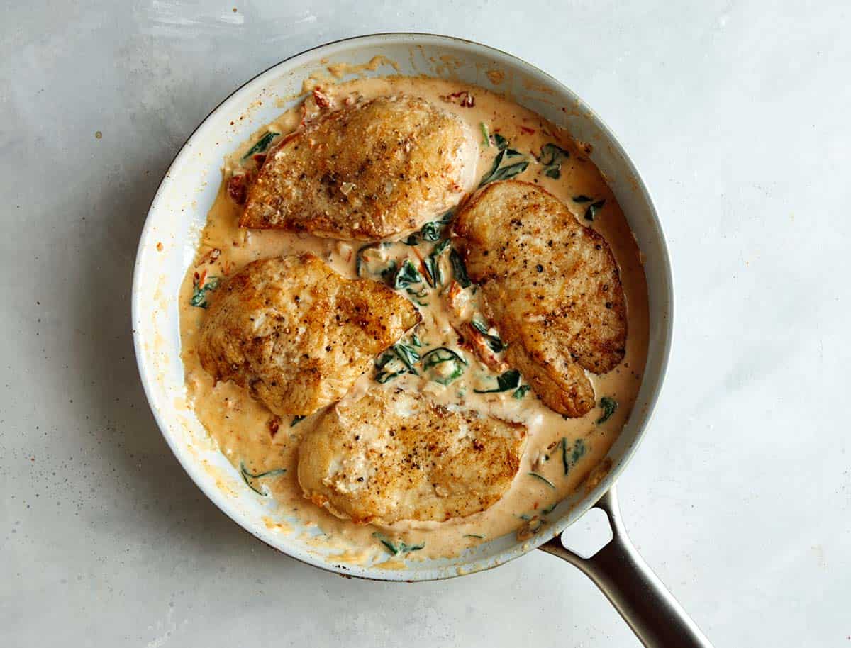 Tuscan chicken in a skillet ready to be served.