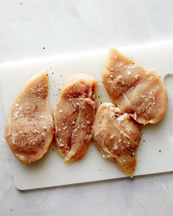 Seasoned chicken breasts to make tuscan chicken. 