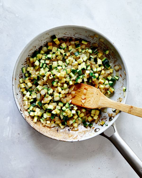 Zucchini, onions, and garlic in a skillet to make Jajangmyeon.