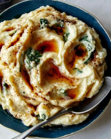 Brown Butter Colcannon recipe in a bowl with a spoon in it.