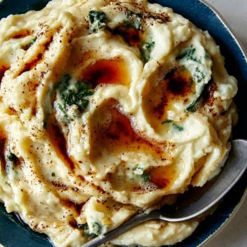 Brown Butter Colcannon recipe in a bowl with a spoon in it.