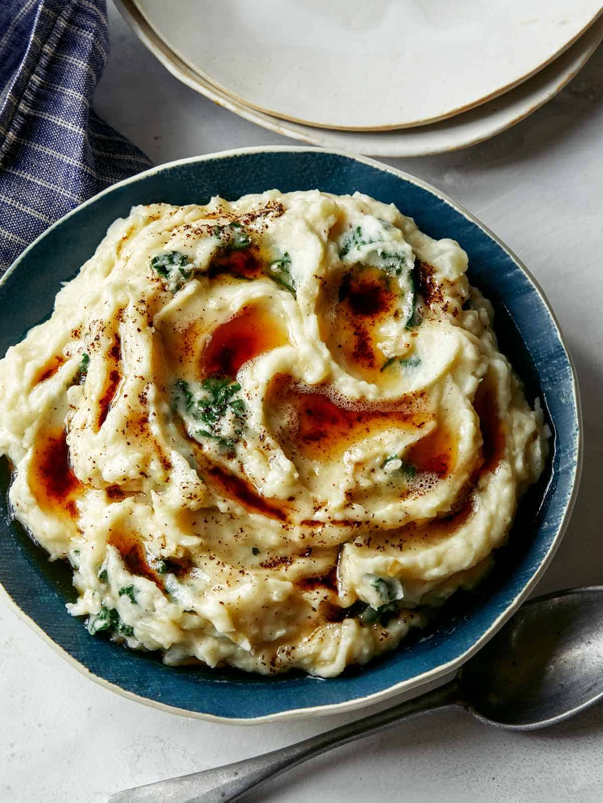 Colcannon in a big bowl with brown butter drizzled on it. 