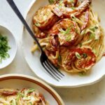 Cajun shrimp pasta recipe in two bowls with a fork in one.
