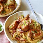 Two bowls of cajun shrimp pasta.