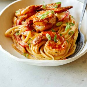 Cajun shrimp pasta recipe in a bowl with a fork in it.