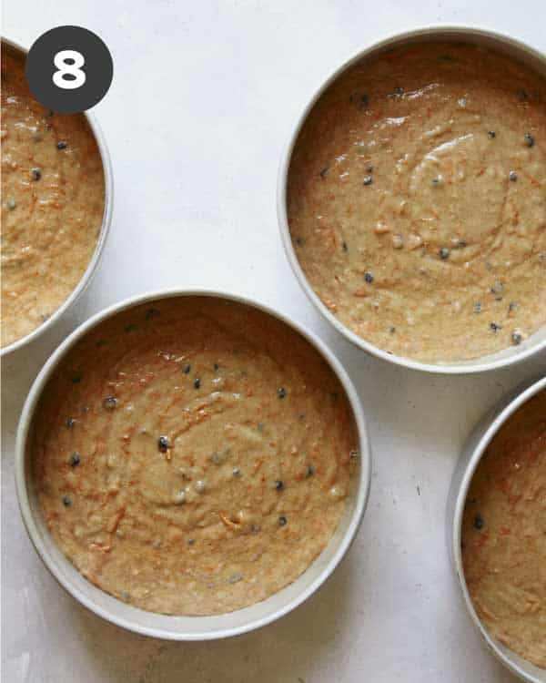 Carrot cake batter in cake rounds ready to go into an oven.